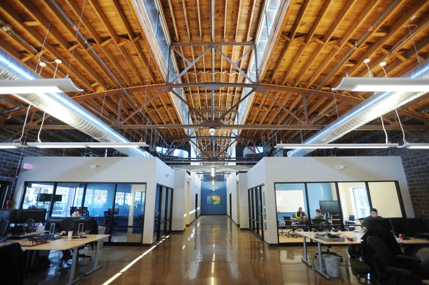 From the exposed brick walls to skylights and an open wood rafter ceiling, HookLogic general manager Gary Evans said the building has attractive aesthetics that make for a unique office space. The tech company renovated the former Leopold Bros. brewery in Ann Arbor.